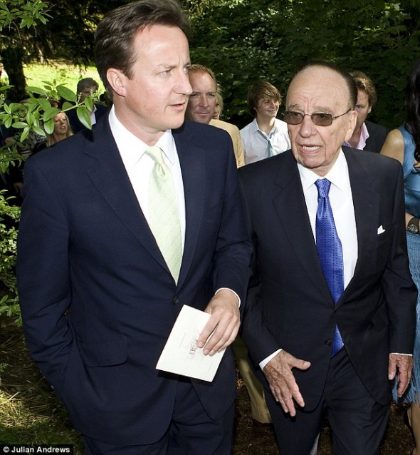 David Cameron talking to Rupert Murdoch at the wedding of Rebecca Wade, former C.E.O of News International, a Murdoch-owned company.  Image via The Daily Mail.